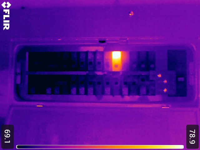 Thermal image of the same breaker panel revealing one overheating breaker