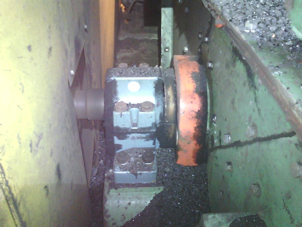 Visible-light photo of an industrial bearing housing covered in debris